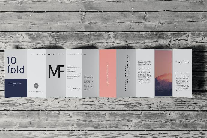 a folded brochure on a wooden surface